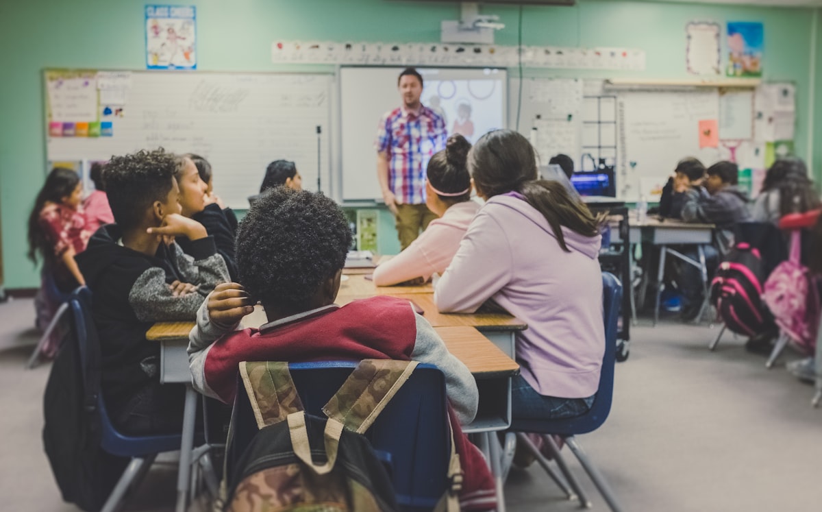 A teacher leading a discussion in a classroom full of students